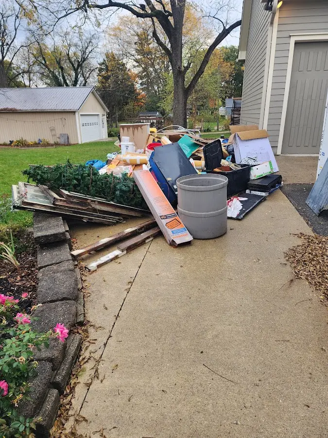 Dumpster being loaded with debris for 12 Yard Dumpster Rental in Fort Oglethorpe